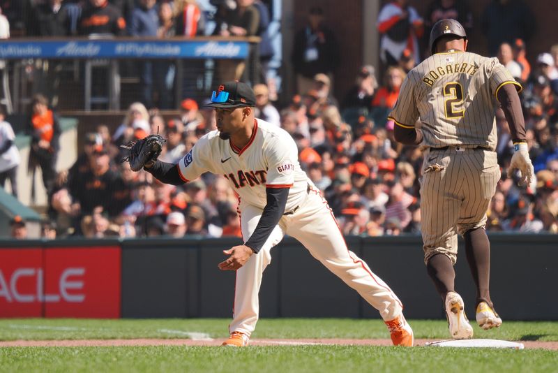 Apr 5, 2024; San Francisco, California, USA; San Francisco Giants first baseman LaMonte Wade Jr. (31) forces out San Diego Padres second baseman Xander Bogaerts (2) at first base during the eighth inning at Oracle Park. Mandatory Credit: Kelley L Cox-USA TODAY Sports