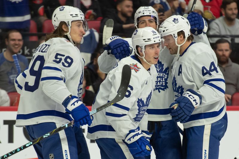 Dec 7, 2023; Ottawa, Ontario, CAN; Toronto Maple Leafs right wing Mitchell Marner (16) celebrates with team his goal scored in the second period against the Ottawa Senators at the Canadian Tire Centre. Mandatory Credit: Marc DesRosiers-USA TODAY Sports