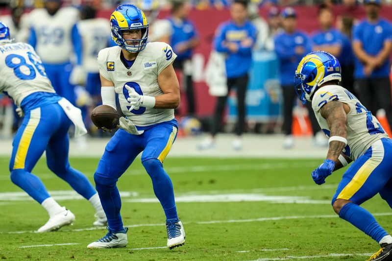 Los Angeles Rams quarterback Matthew Stafford (9) works in the pocket against the Arizona Cardinals during the first half of an NFL football game, Sunday, Sept. 15, 2024, in Glendale, Ariz. (AP Photo/Ross D. Franklin)