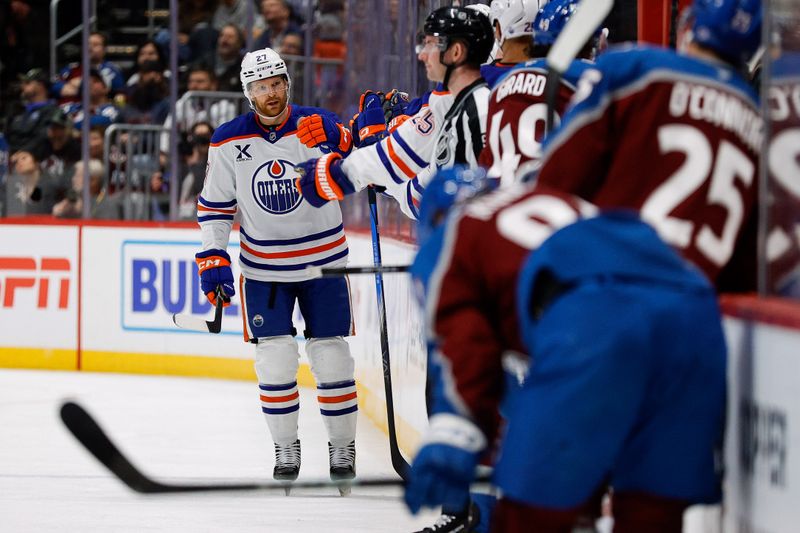 Jan 16, 2025; Denver, Colorado, USA; Edmonton Oilers defenseman Brett Kulak (27) celebrates with the bench after his goal in the second period against the Colorado Avalanche at Ball Arena. Mandatory Credit: Isaiah J. Downing-Imagn Images