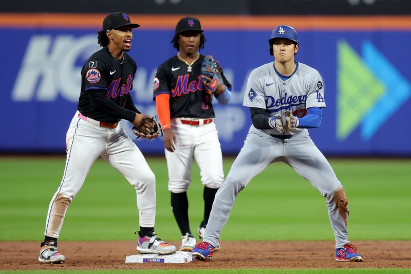 May 23, 2025; New York City, New York, USA; Los Angeles Dodgers designated hitter Shohei Ohtani (17) reacts after tagging up and taking second base on a sacrifice fly by Dodgers shortstop Mookie Betts (not pictured) in front of New York Mets shortstop Francisco Lindor (12) and second baseman Luisangel Acuna (2) during the third inning at Citi Field. Mandatory Credit: Brad Penner-Imagn Images