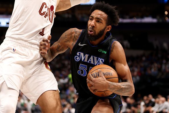 DALLAS, TEXAS - DECEMBER 27: Derrick Jones Jr. #55 of the Dallas Mavericks drives to the basket against Max Strus #1 of the Cleveland Cavaliers in the second half at American Airlines Center on December 27, 2023 in Dallas, Texas. NOTE TO USER: User expressly acknowledges and agrees that, by downloading and or using this photograph, User is consenting to the terms and conditions of the Getty Images License Agreement. (Photo by Tim Heitman/Getty Images)