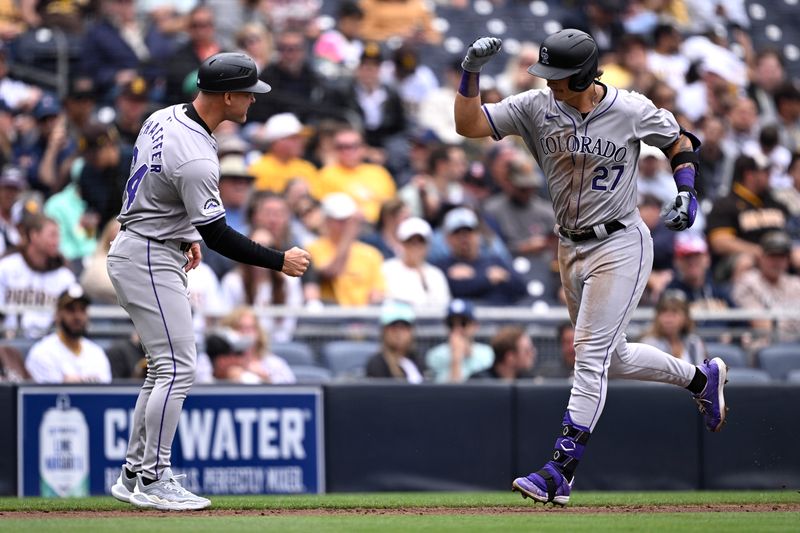 May 15, 2024; San Diego, California, USA; Colorado Rockies left fielder Jordan Beck (27) is congratulated by third base coach Warren Schaeffer (34) while rounding the bases after hitting a two-run home run against the San Diego Padres during the sixth inning at Petco Park. Mandatory Credit: Orlando Ramirez-USA TODAY Sports