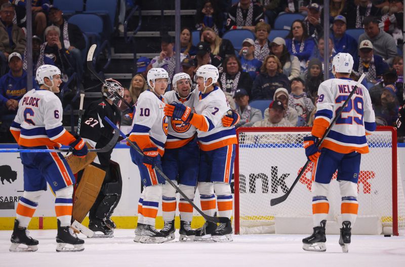 Nov 1, 2024; Buffalo, New York, USA;  New York Islanders center Kyle Palmieri (21) celebrates his goal with teammates during the second period against the Buffalo Sabres at KeyBank Center. Mandatory Credit: Timothy T. Ludwig-Imagn Images
