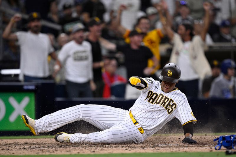 Aug 4, 2023; San Diego, California, USA; San Diego Padres left fielder Juan Soto (22) slides home to score a run against the Los Angeles Dodgers during the eighth inning at Petco Park. Mandatory Credit: Orlando Ramirez-USA TODAY Sports