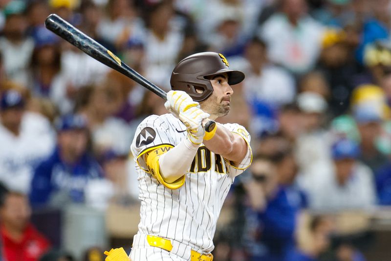 Jun 9, 2025; San Diego, California, USA; San Diego Padres left fielder Tyler Wade (14) hits a three run triple during the third inning against the Los Angeles Dodgers at Petco Park. Mandatory Credit: David Frerker-Imagn Images