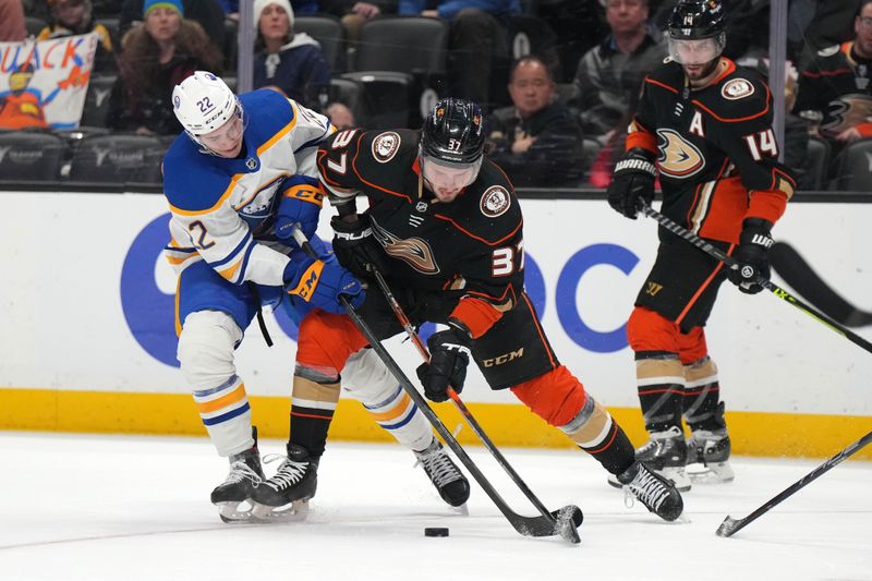 Feb 15, 2023; Anaheim, California, USA; Buffalo Sabres right wing Jack Quinn (22) and Anaheim Ducks center Mason McTavish (37) battle for the puck in the second period at Honda Center. Mandatory Credit: Kirby Lee-USA TODAY Sports