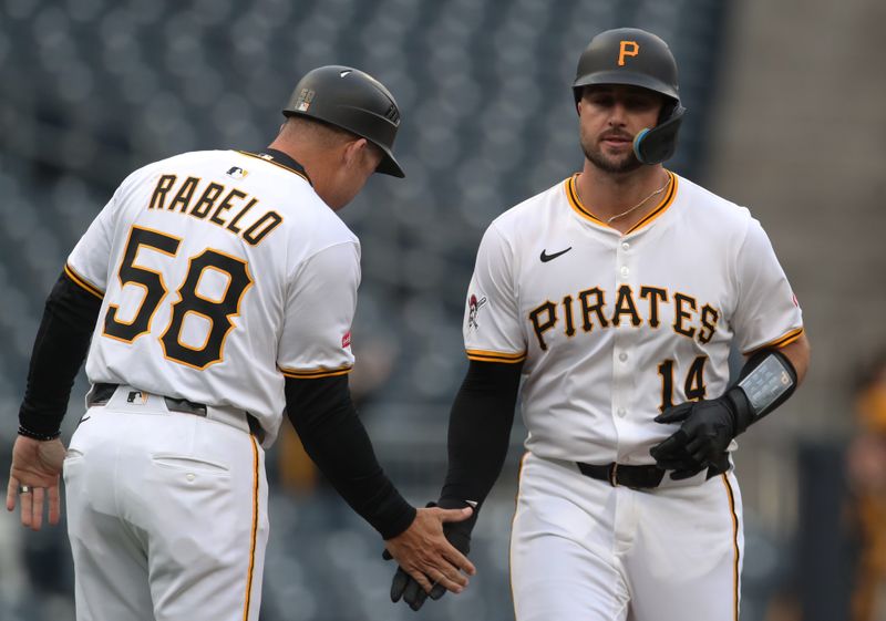 Apr 7, 2025; Pittsburgh, Pennsylvania, USA;  Pittsburgh Pirates third base coach Mike Rabelo (58) congratulates catcher Joey Bart (14) as he circles the bases on a solo home run against the St. Louis Cardinals during the first inning at PNC Park. Mandatory Credit: Charles LeClaire-Imagn Images