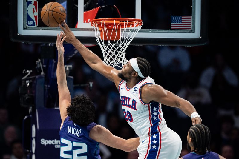 CHARLOTTE, NORTH CAROLINA - DECEMBER 03: Guerschon Yabusele #28 of the Philadelphia 76ers blocks a shot from Vasilije Micic #22 of the Charlotte Hornets in the third quarter of the game during the Emirates NBA Cup at Spectrum Center on December 03, 2024 in Charlotte, North Carolina. NOTE TO USER: User expressly acknowledges and agrees that, by downloading and or using this photograph, User is consenting to the terms and conditions of the Getty Images License Agreement. (Photo by Jacob Kupferman/Getty Images)