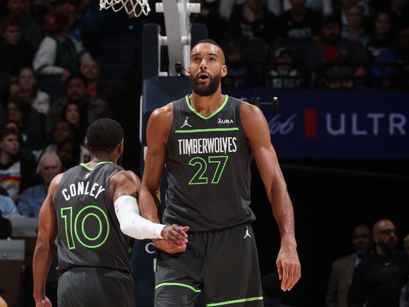 MINNEAPOLIS, MN -  APRIL 2:  Rudy Gobert #27 and Mike Conley #10 of the Minnesota Timberwolves high five during the game against the Houston Rockets on April 2, 2024 at Target Center in Minneapolis, Minnesota. NOTE TO USER: User expressly acknowledges and agrees that, by downloading and or using this Photograph, user is consenting to the terms and conditions of the Getty Images License Agreement. Mandatory Copyright Notice: Copyright 2024 NBAE (Photo by David Sherman/NBAE via Getty Images)