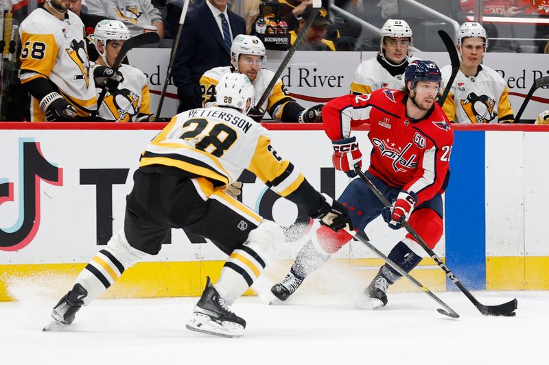 Nov 8, 2024; Washington, District of Columbia, USA; Washington Capitals right wing Brandon Duhaime (22) skates with the puck as Pittsburgh Penguins defenseman Marcus Pettersson (28) defends in the third period at Capital One Arena. Mandatory Credit: Geoff Burke-Imagn Images