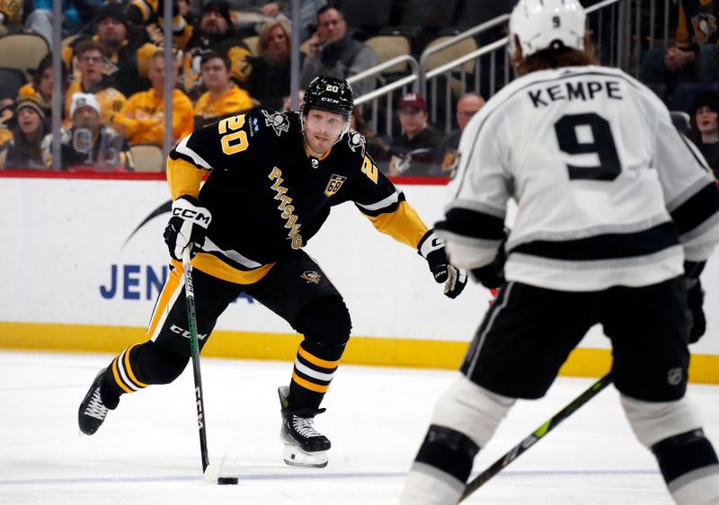 Feb 18, 2024; Pittsburgh, Pennsylvania, USA;  Pittsburgh Penguins center Lars Eller (20) skates with the puck against Los Angeles Kings right wing Adrian Kempe (9) during the third period at PPG Paints Arena. Los Angeles won 2-1. Mandatory Credit: Charles LeClaire-USA TODAY Sports