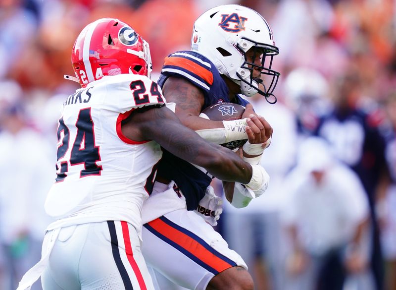 Sep 30, 2023; Auburn, Alabama, USA; Auburn Tigers running back Jarquez Hunter (27) carries the ball against Georgia Bulldogs defensive back Malaki Starks (24) during the first quarter at Jordan-Hare Stadium. Mandatory Credit: John David Mercer-USA TODAY Sports