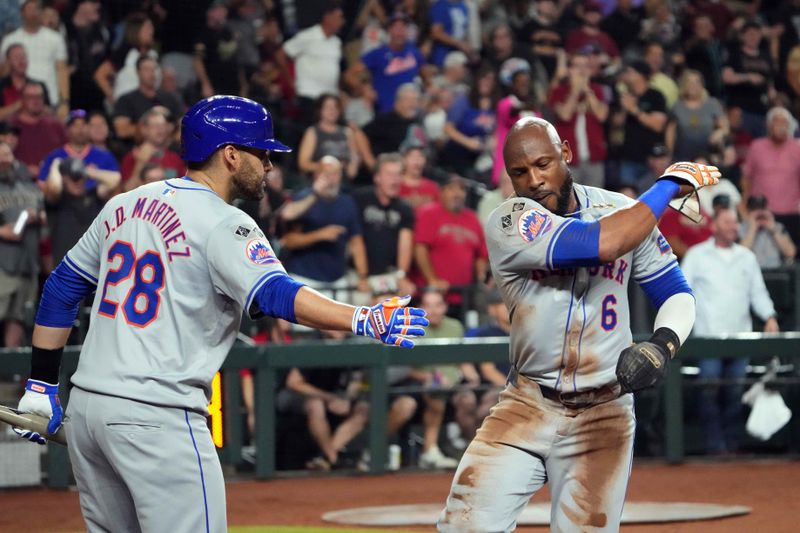 Aug 28, 2024; Phoenix, Arizona, USA; New York Mets outfielder Starling Marte (6) celebrates with New York Mets designated hitter J.D. Martinez (28) after scoring a run against the Arizona Diamondbacks during the sixth inning at Chase Field. Mandatory Credit: Joe Camporeale-USA TODAY Sports
