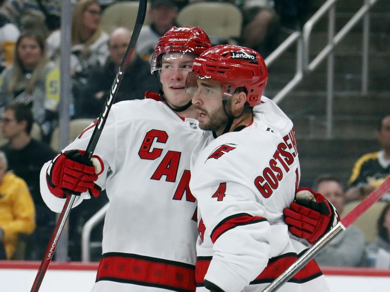 Oct 18, 2024; Pittsburgh, Pennsylvania, USA;  Carolina Hurricanes right wing Andrei Svechnikov (37) and defenseman Shayne Gostisbehere (4) celebrate a goal by Gostisbehere against the Pittsburgh Penguins during the second period at PPG Paints Arena. Mandatory Credit: Charles LeClaire-Imagn Images