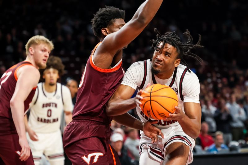 Dec 2, 2025; Columbia, South Carolina, USA; South Carolina Gamecocks guard Kobe Knox (4) looks to shoot around Virginia Tech Hokies guard Tyler Johnson (10) in the first half at Colonial Life Arena. Mandatory Credit: Jeff Blake-Imagn Images