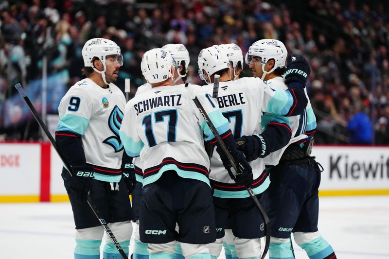 Nov 5, 2024; Denver, Colorado, USA; Members of the Seattle Kraken a goal scored in the third period against the Colorado Avalanche at Ball Arena. Mandatory Credit: Ron Chenoy-Imagn Images