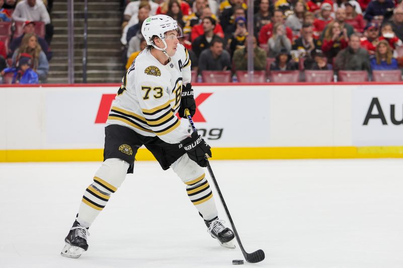 Nov 22, 2023; Sunrise, Florida, USA; Boston Bruins defenseman Charlie McAvoy (73) moves the puck against the Florida Panthers during the first period at Amerant Bank Arena. Mandatory Credit: Sam Navarro-USA TODAY Sports