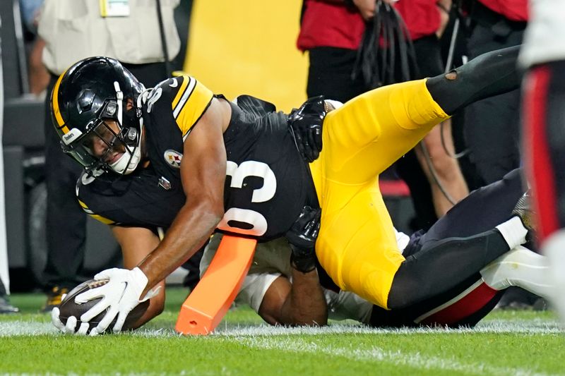 Pittsburgh Steelers tight end Connor Heyward (83) dives for the end zone and a touchdown with Houston Texans safety M.J. Stewart, rear, defending, during the second half of an NFL exhibition football game, Friday, Aug. 9, 2024, in Pittsburgh. (AP Photo/Matt Freed)