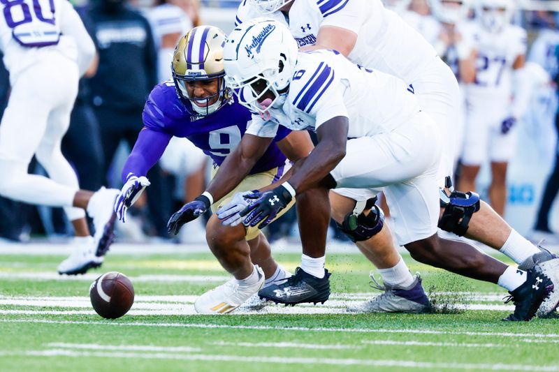 Sep 21, 2024; Seattle, Washington, USA; Northwestern Wildcats running back Joseph Himon II (6) recovers his fumble against Washington Huskies edge Isaiah Ward (91) during the second quarter at Alaska Airlines Field at Husky Stadium. Mandatory Credit: Joe Nicholson-Imagn Images