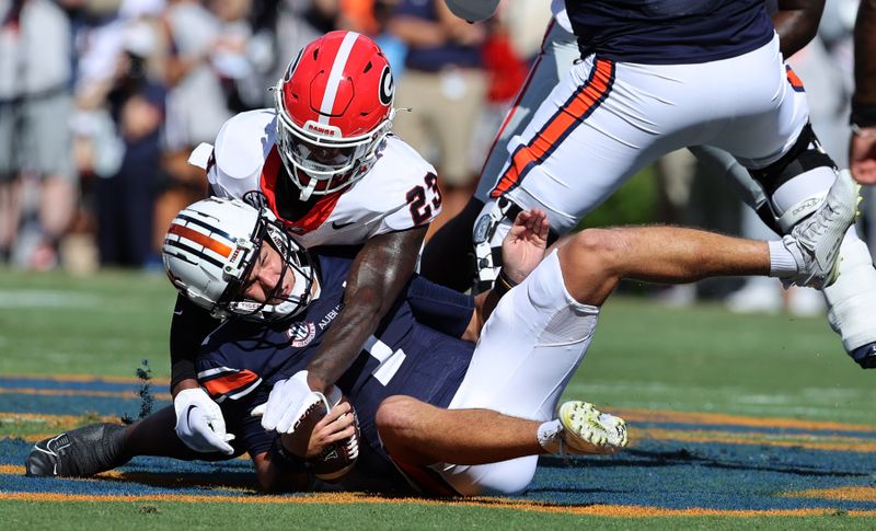 Sep 30, 2023; Auburn, Alabama, USA; Auburn Tigers quarterback Payton Thorne (1) is sacked by Georgia Bulldogs defensive back Tykee Smith (23) during the first quarter at Jordan-Hare Stadium. Mandatory Credit: John Reed-USA TODAY Sports