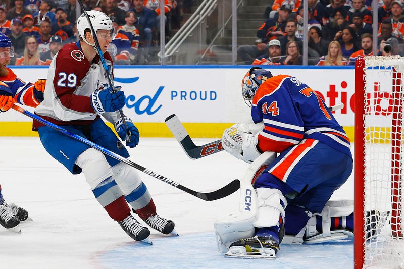 Mar 16, 2024; Edmonton, Alberta, CAN; Edmonton Oilers goaltender Stuart Skinner (74) makes a save on a deflection by Colorado Avalanche forward Nathan MacKinnon (29) during the second period at Rogers Place. Mandatory Credit: Perry Nelson-USA TODAY Sports