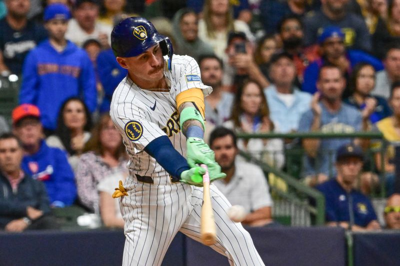 Sep 28, 2024; Milwaukee, Wisconsin, USA; Milwaukee Brewers third baseman Joey Ortiz (3) drives in two runs with a base hit in the fourth inning against the New York Mets at American Family Field. Mandatory Credit: Benny Sieu-Imagn Images