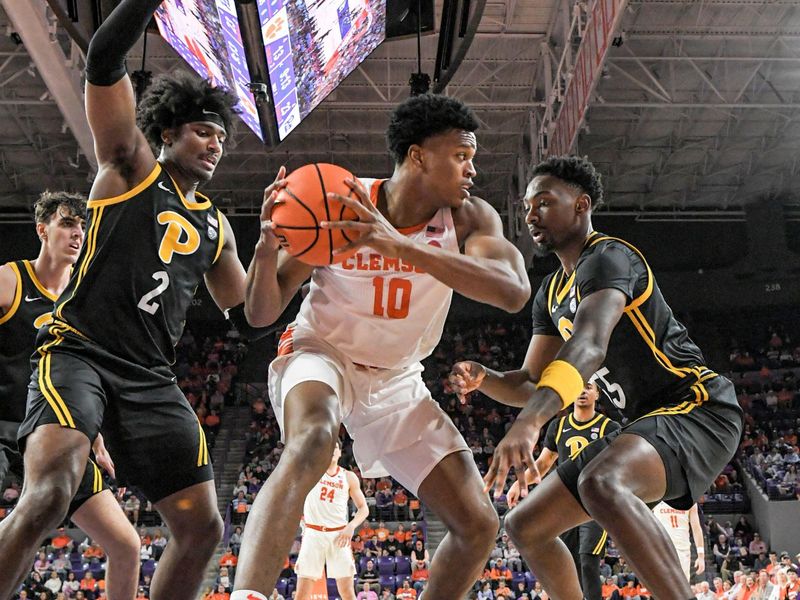 Feb 27, 2024; Clemson, South Carolina, USA;  Clemson sophomore RJ Godfrey (10) tries to take a shot near Pitt forward Blake Hinson (2) and Pitt forward Zack Austin (55) during the first half at Littlejohn Coliseum. Mandatory Credit: Ken Ruinard-USA TODAY Sports