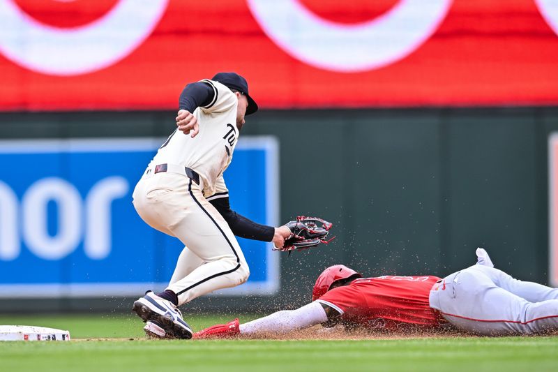 Apr 27, 2025; Minneapolis, Minnesota, USA; Minnesota Twins second base Edouard Julien (47) goes to tag out Los Angeles Angels third base Luis Rengifo (2) attempting to steal second base during the fifth inning at Target Field. Mandatory Credit: Jeffrey Becker-Imagn Images