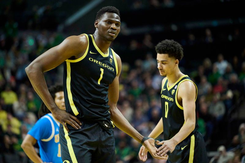 Feb 11, 2023; Eugene, Oregon, USA; Oregon Ducks center N'Faly Dante (1) gets a high five during the first half from teammate guard Will Richardson (0) at Matthew Knight Arena. Mandatory Credit: Troy Wayrynen-USA TODAY Sports