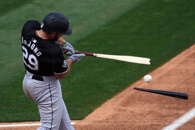 Mar 3, 2024; Tempe, Arizona, USA; Chicago White Sox shortstop Paul DeJong (29) breaks his bat on a swing against the Los Angeles Angels during the third inning at Tempe Diablo Stadium. Mandatory Credit: Joe Camporeale-USA TODAY Sports