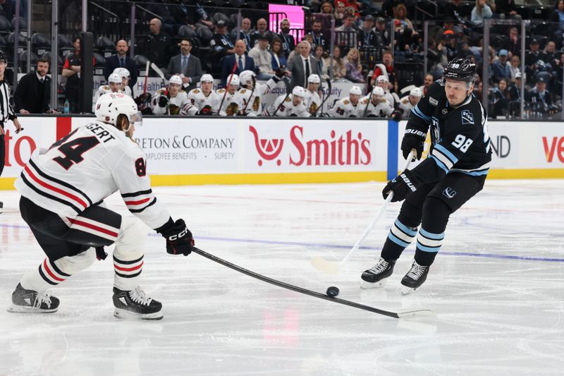 Mar 1, 2026; Salt Lake City, Utah, USA; Utah Mammoth defenseman Mikhail Sergachev (98) skates with the puck against Chicago Blackhawks left wing Landon Slaggert (84) during the second period at Delta Center. Mandatory Credit: Rob Gray-Imagn Images