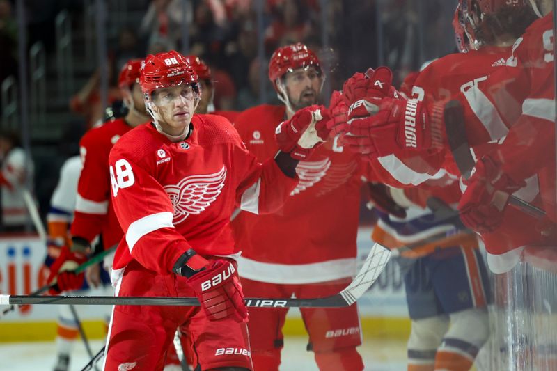 Feb 29, 2024; Detroit, Michigan, USA;  Detroit Red Wings right wing Patrick Kane (88) receives congratulations from teammates after scoring in the third period against the New York Islanders at Little Caesars Arena. Mandatory Credit: Rick Osentoski-USA TODAY Sports