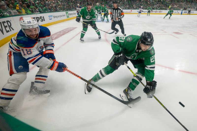 May 25, 2024; Dallas, Texas, USA; Edmonton Oilers left wing Zach Hyman (18) and Dallas Stars left wing Jason Robertson (21) battle for control of the puck during the third period in game two of the Western Conference Final of the 2024 Stanley Cup Playoffs at American Airlines Center. Mandatory Credit: Jerome Miron-USA TODAY Sports