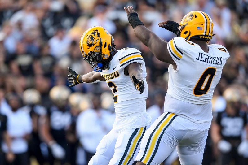 Sep 30, 2023; Nashville, Tennessee, USA; Missouri Tigers safety Ennis Rakestraw Jr. (2) and defensive lineman Jayden Jernigan (0) celebrate Rakestraw Jr.   s tackle for a loss of Vanderbilt Commodores tight end Justin Ball (84) during the first half at FirstBank Stadium. Mandatory Credit: Steve Roberts-USA TODAY Sports