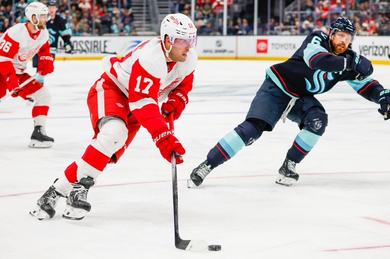 Feb 19, 2024; Seattle, Washington, USA; Detroit Red Wings right wing Daniel Sprong (17) skates with the puck against the Seattle Kraken during the third period at Climate Pledge Arena. Mandatory Credit: Joe Nicholson-USA TODAY Sports