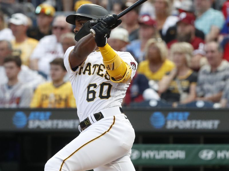 Aug 8, 2023; Pittsburgh, Pennsylvania, USA;  Pittsburgh Pirates shortstop Liover Peguero (60) hits a single against the Atlanta Braves during the first inning at PNC Park. Mandatory Credit: Charles LeClaire-USA TODAY Sports