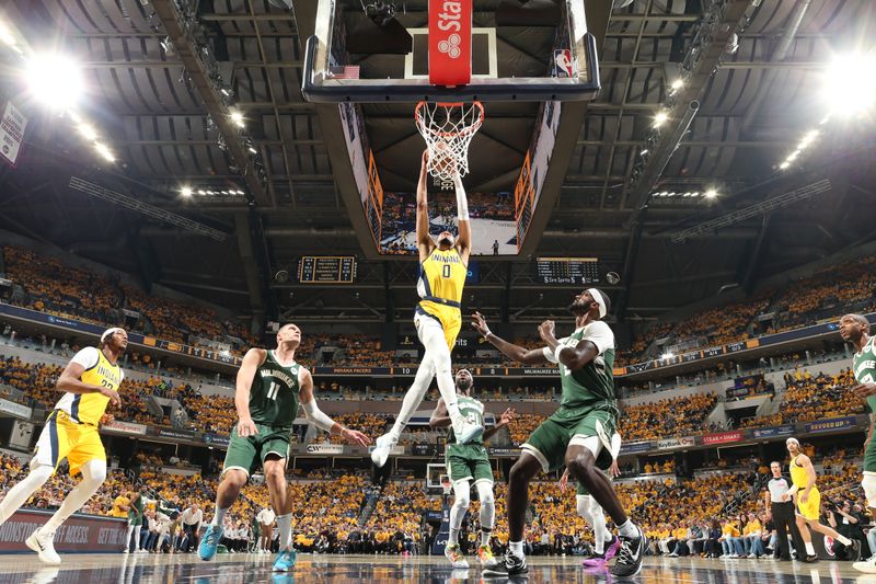 INDIANAPOLIS, IN - APRIL 26: Tyrese Haliburton #0 of the Indiana Pacers dunks the ball during the game against the Milwaukee Bucks during Round 1 Game 3 of the 2024 NBA Playoffs on April 26, 2024 at Gainbridge Fieldhouse in Indianapolis, Indiana. NOTE TO USER: User expressly acknowledges and agrees that, by downloading and or using this Photograph, user is consenting to the terms and conditions of the Getty Images License Agreement. Mandatory Copyright Notice: Copyright 2023 NBAE (Photo by Nathaniel S. Butler/NBAE via Getty Images)