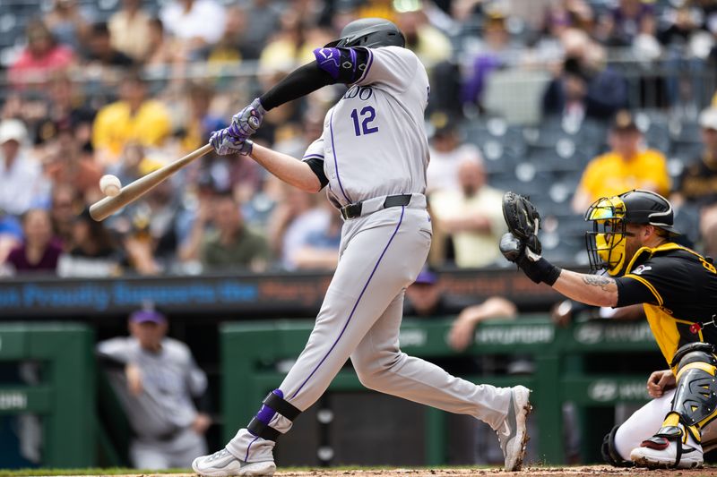 May 5, 2024; Pittsburgh, Pennsylvania, USA; Colorado Rockies right fielder Sean Bouchard (12) hits a solo home run against the Pittsburgh Pirates during the second inning at PNC Park. Mandatory Credit: Scott Galvin-USA TODAY Sports