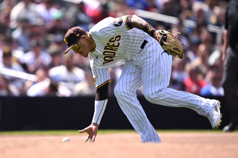 Apr 19, 2023; San Diego, California, USA; San Diego Padres third baseman Manny Machado (13) fields a ball bare-handed before throwing to first base during the seventh inning against the Atlanta Braves at Petco Park. Mandatory Credit: Orlando Ramirez-USA TODAY Sports