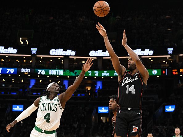 BOSTON, MASSACHUSETTS - DECEMBER 28: Alec Burks #14 of the Detroit Pistons attempts a three-point basket in front of Jrue Holiday #4 of the Boston Celtics during the third quarter at TD Garden on December 28, 2023 in Boston, Massachusetts. NOTE TO USER: User expressly acknowledges and agrees that, by downloading and or using this photograph, User is consenting to the terms and conditions of the Getty Images License Agreement. (Photo by Brian Fluharty/Getty Images)