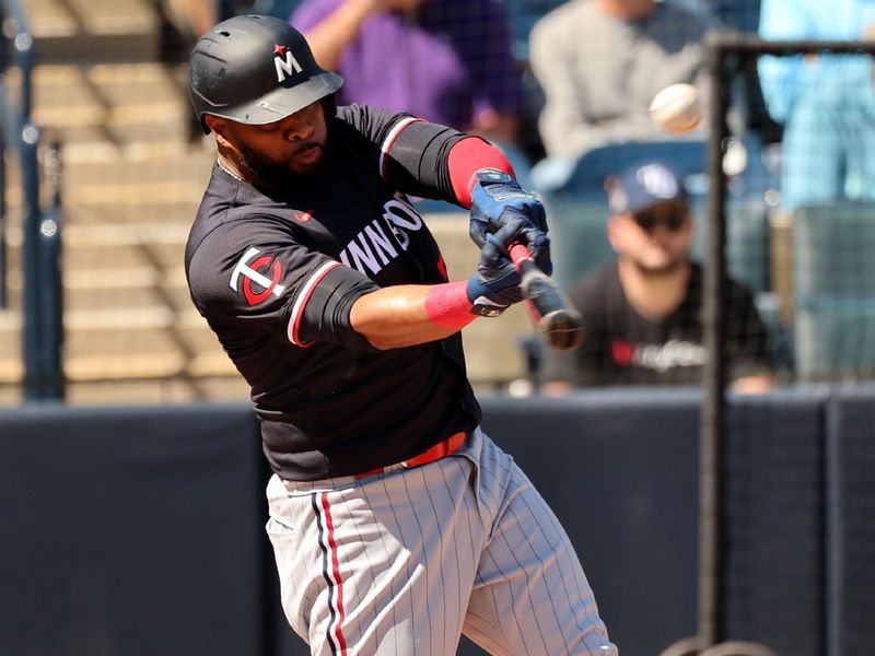 Feb 26, 2024; Tampa, Florida, USA; Minnesota Twins first baseman Carlos Santana (30) singles during the first inning against the New York Yankees  at George M. Steinbrenner Field. Mandatory Credit: Kim Klement Neitzel-USA TODAY Sports