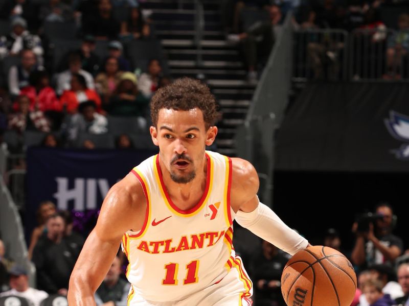 CHARLOTTE, NC - FEBRUARY 14: Trae Young #11 of the Atlanta Hawks dribbles the ball during the game against the Charlotte Hornets on February 14, 2024 at Spectrum Center in Charlotte, North Carolina. NOTE TO USER: User expressly acknowledges and agrees that, by downloading and or using this photograph, User is consenting to the terms and conditions of the Getty Images License Agreement. Mandatory Copyright Notice: Copyright 2024 NBAE (Photo by Kent Smith/NBAE via Getty Images)