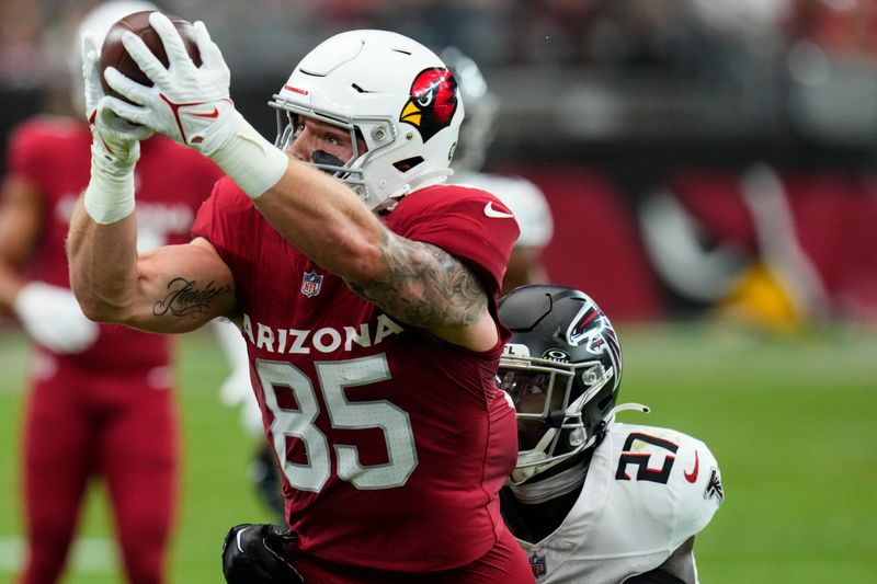 Arizona Cardinals tight end Trey McBride (85) makes the catch against Atlanta Falcons safety Richie Grant (27) during the first half of an NFL football game, Sunday, Nov. 12, 2023, in Glendale, Ariz. (AP Photo/Ross D. Franklin)