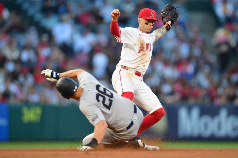 May 28, 2024; Anaheim, California, USA; New York Yankees third baseman DJ LeMahieu (26) reaches second against Los Angeles Angels shortstop Zach Neto (9) during the fourth inning at Angel Stadium. Mandatory Credit: Gary A. Vasquez-USA TODAY Sports