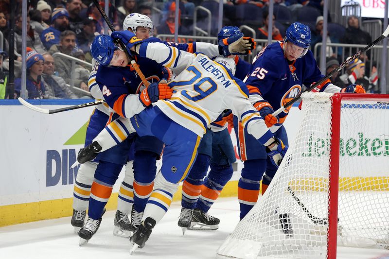 Nov 30, 2024; Elmont, New York, USA; New York Islanders defenseman Grant Hutton (34) and Buffalo Sabres left wing Beck Malenstyn (29) collide behind the goal during the first period at UBS Arena. Mandatory Credit: Brad Penner-Imagn Images