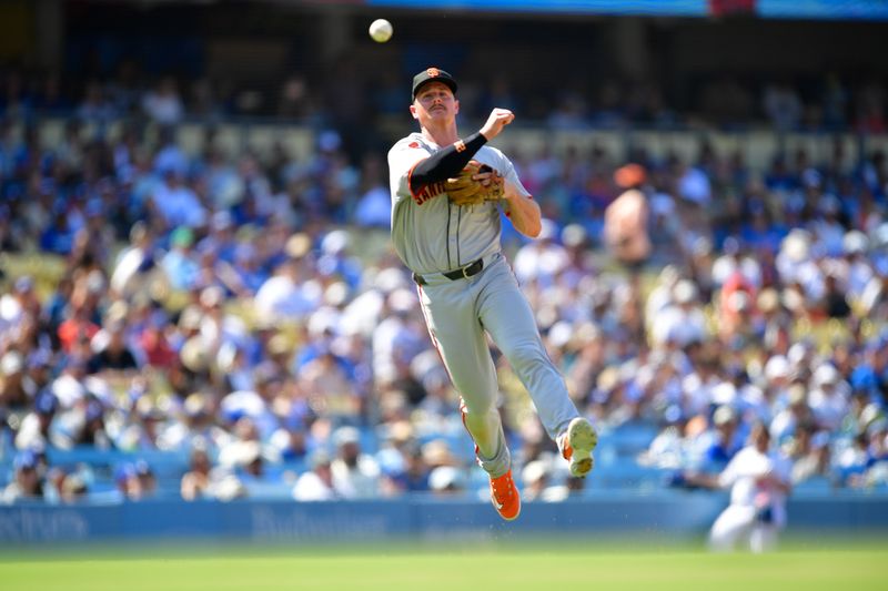 Jul 25, 2024; Los Angeles, California, USA; San Francisco Giants third baseman Matt Chapman (26) throws to first for the out against Los Angeles Dodgers center fielder Andy Pages (44) during the eighth inning at Dodger Stadium. Mandatory Credit: Gary A. Vasquez-USA TODAY Sports