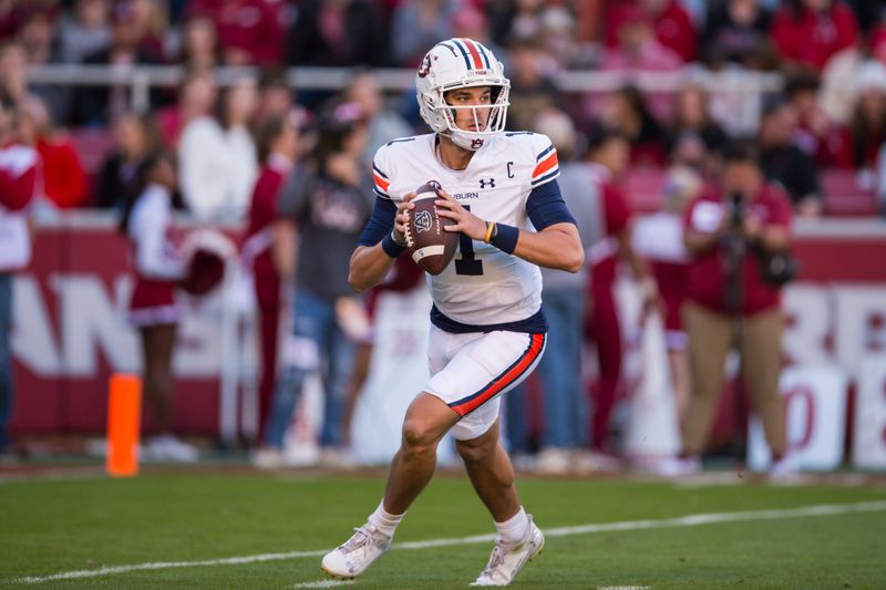 Nov 11, 2023; Fayetteville, Arkansas, USA;  Auburn Tigers quarterback Payton Thorne (1) rolls out to pass during the second quarter against the Arkansas Razorbacks at Donald W. Reynolds Razorback Stadium. Mandatory Credit: Brett Rojo-USA TODAY Sports