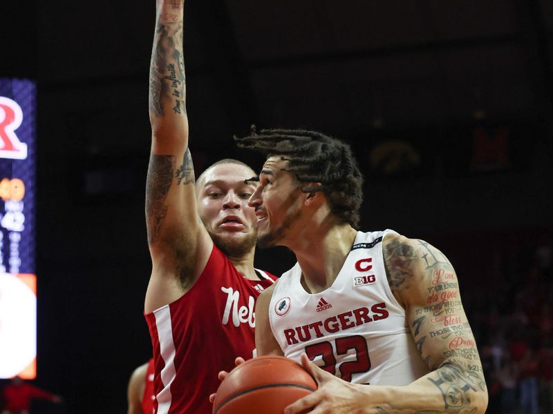 Feb 14, 2023; Piscataway, New Jersey, USA; Rutgers Scarlet Knights guard Caleb McConnell (22) goes to the basket against Nebraska Cornhuskers guard C.J. Wilcher (0)  during the second half at Jersey Mike's Arena. Mandatory Credit: Vincent Carchietta-USA TODAY Sports