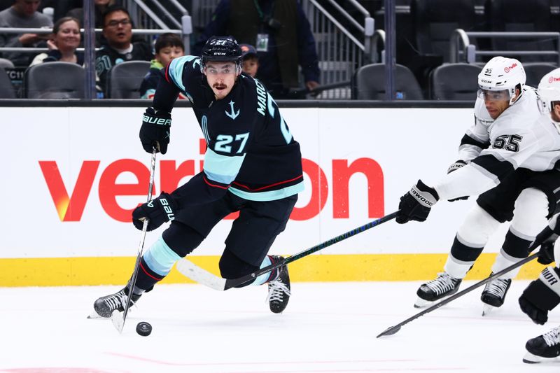 Dec 10, 2025; Seattle, Washington, USA; Seattle Kraken left wing Mason Marchment (27) moves the puck past Los Angeles Kings right wing Quinton Byfield (55) in the third period at Climate Pledge Arena. Mandatory Credit: Kevin Ng-Imagn Images